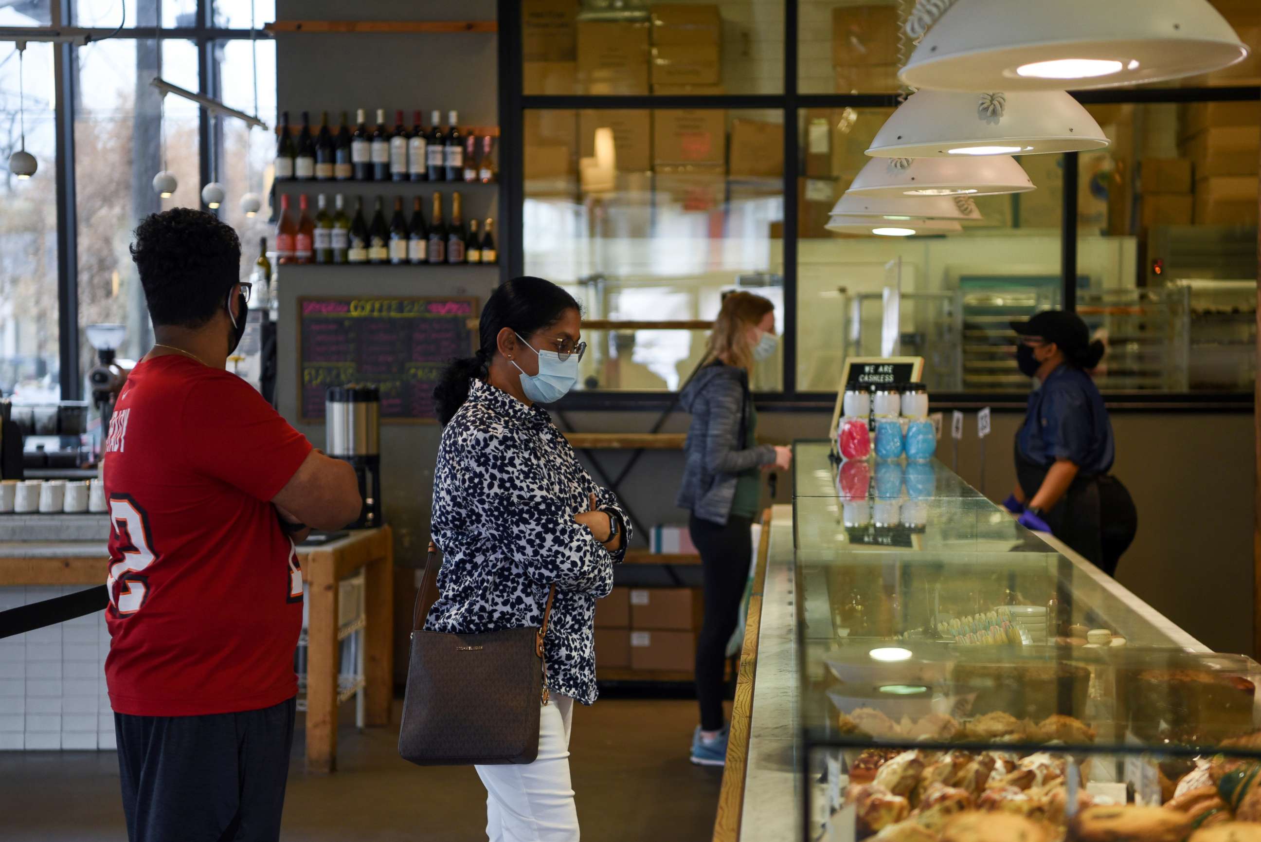 PHOTO: People wait in line to order at a coffee shop during the coronavirus disease  pandemic in Houston, Texas, March 10, 2021.