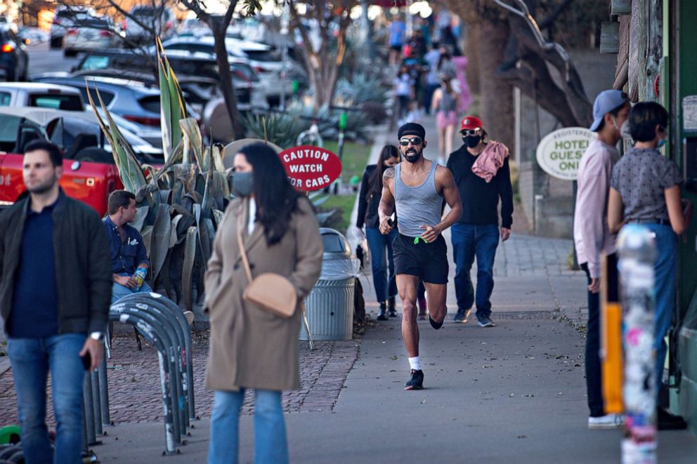 PHOTO: Pedestrians walk down South Congress Ave. on March 3, 2021 in Austin, Texas. Gov. Greg Abbott announced today the state will end its mask mandate and allow businesses to reopen at 100 percent capacity on March 10.