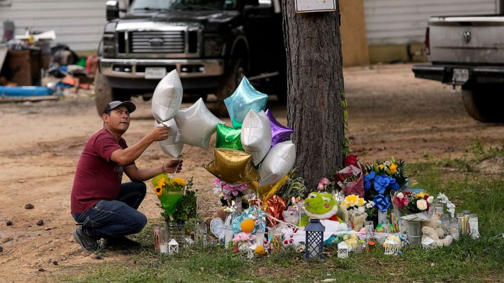 PHOTO: A man releases a balloon from the makeshift memorial outside the victims' home on May 2, 2023 in Cleveland, Texas, where a mass shooting took place on Friday.