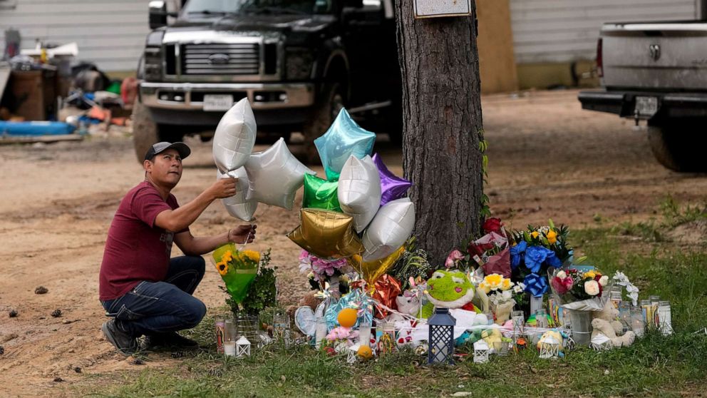 PHOTO: A man releases a balloon from the makeshift memorial outside the victims' home, May 2, 2023, where a mass shooting occurred Friday, in Cleveland, Texas.