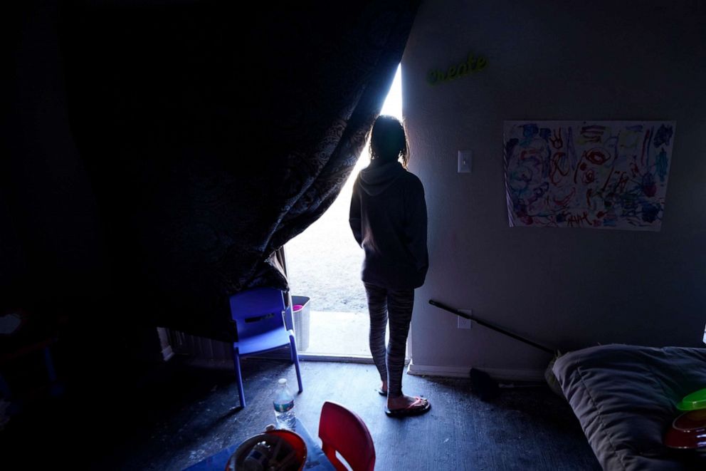 PHOTO: Ricki Mills looks out from her home as she waits for a fire hydrant to be turned to get water, Feb. 23, 2021, in Dallas.