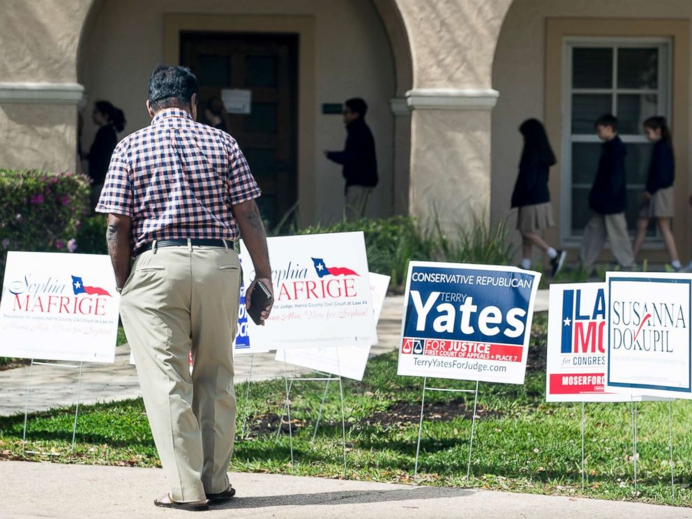 PHOTO: A voter stops to look at primary election signs outside the polling place at St. Annes Catholic Church on Tuesday, March 6, 2018, in Houston.