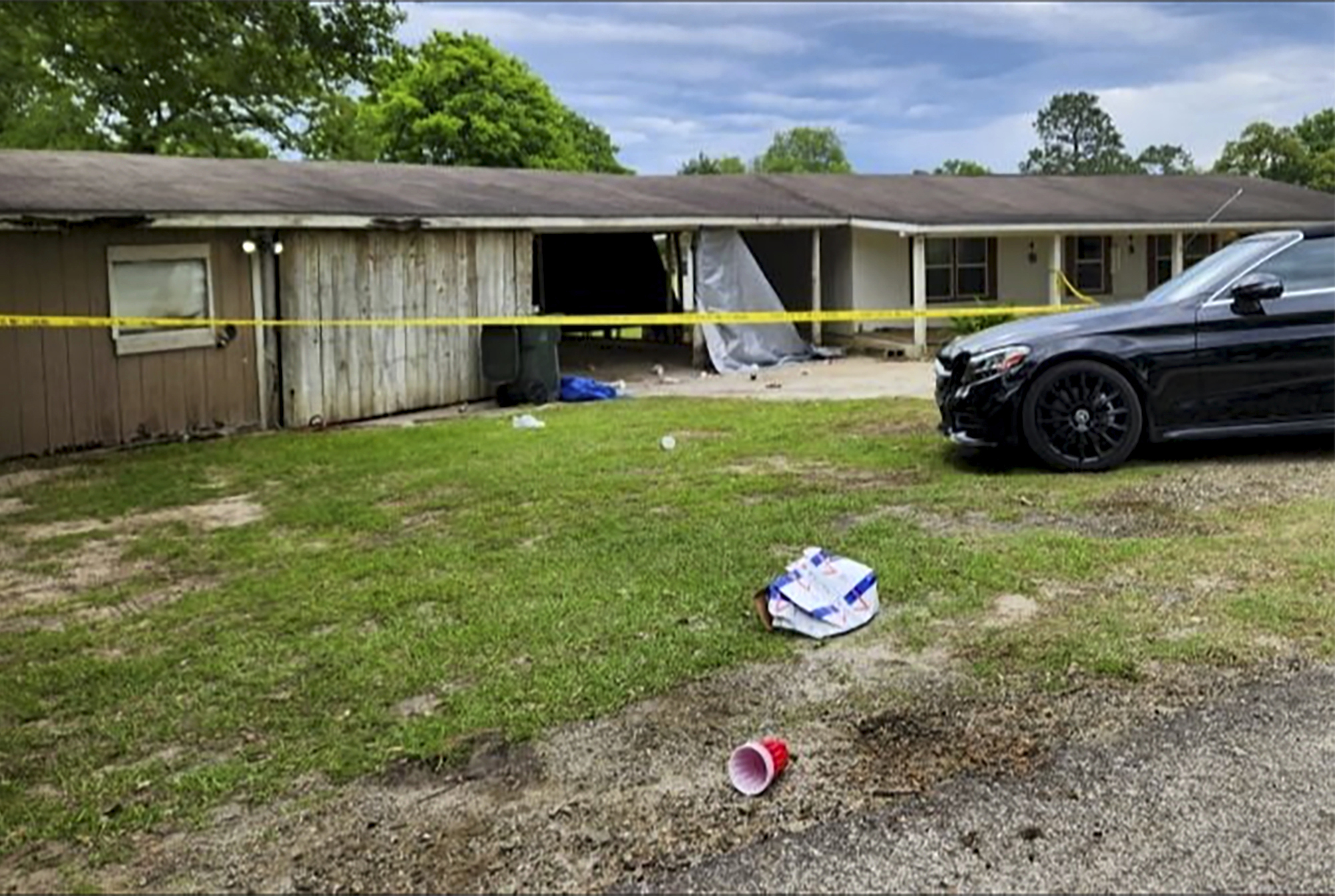 PHOTO: In this photo provided by KJAS, crime scene tape cordons off the scene of a shooting at a prom after-party, April 23, 2023, in Jasper, Texas.