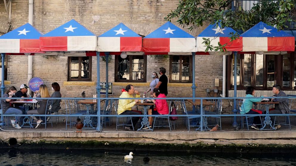 PHOTO: Diners eat at a restaurant on the River Walk, March 3, 2021, in San Antonio.