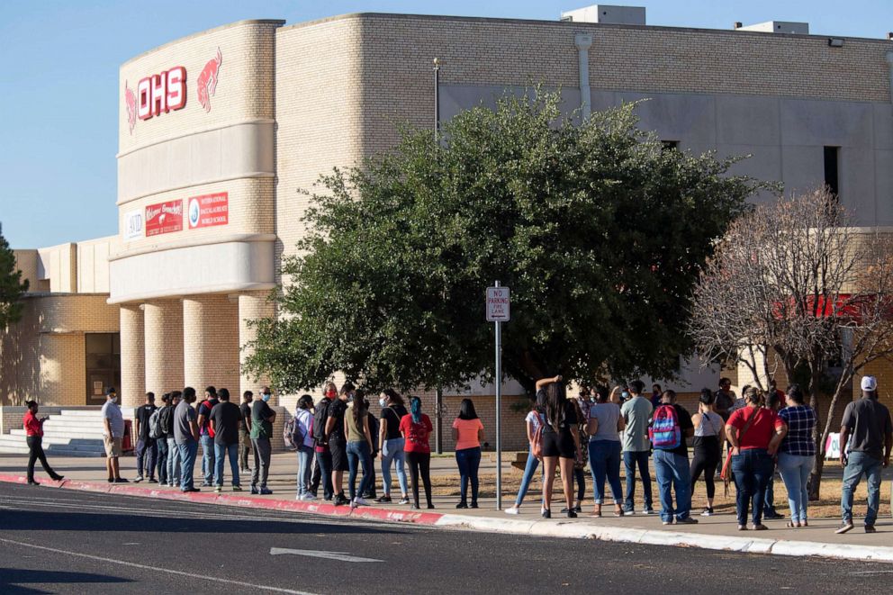 PHOTO: Students wait in line outside of Odessa High School as the first day of the school year begins, Aug. 12, 2020. in Odessa. Texas.