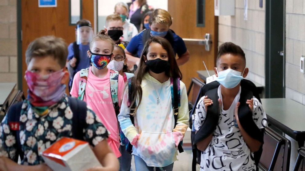 PHOTO: Wearing masks to prevent the spread of COVID19, elementary school students  begin their school day in Godley, Texas, Aug. 5, 2020.