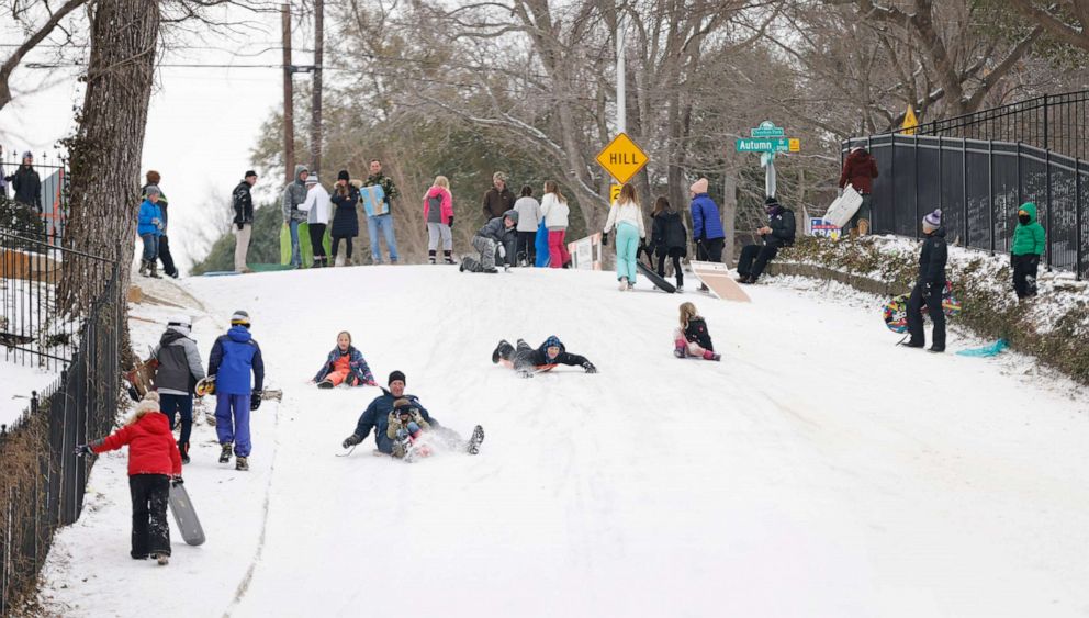 PHOTO: People sled down a hill after a snow storm on Feb. 17, 2021, in Fort Worth, Texas.