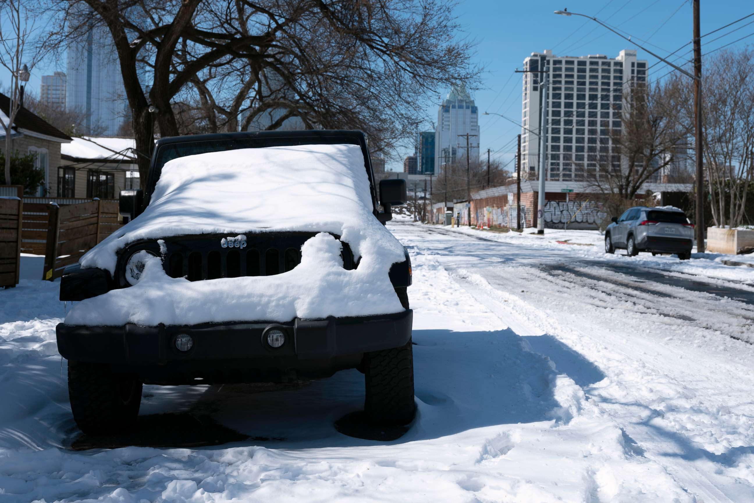 PHOTO: A parked Jeep is covered in snow Tuesday, Feb. 16, 2021, in Austin, Texas. Temperatures dropped into the single digits as snow shut down air travel and grocery stores.