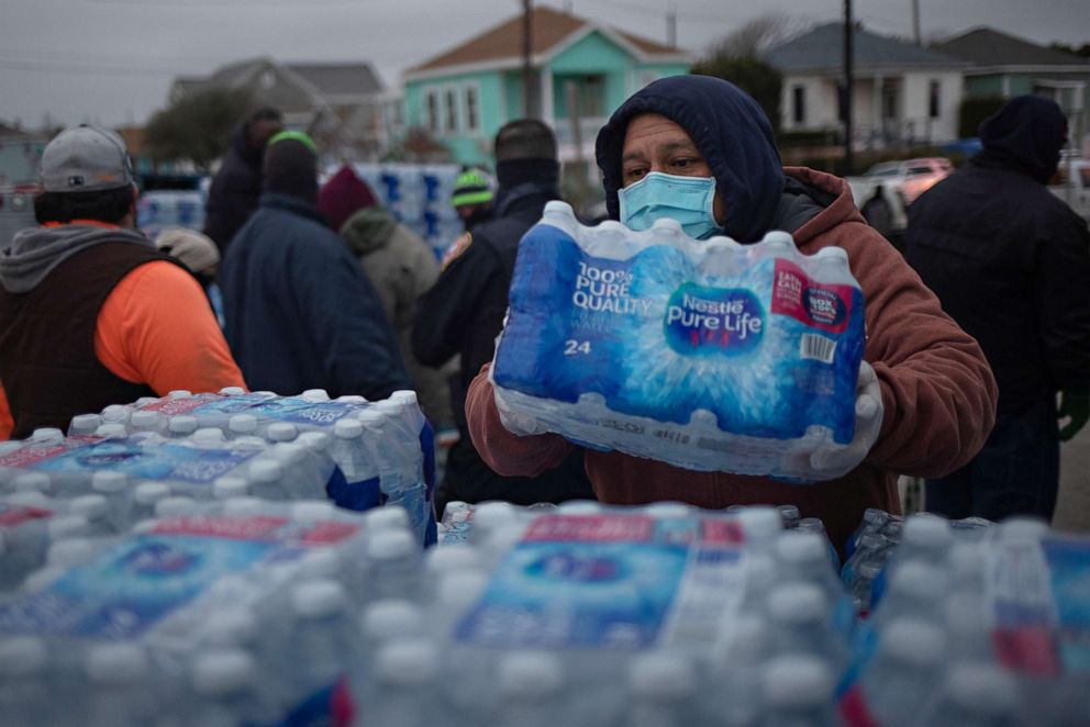 PHOTO: Volunteers help distribute water to local residents at a warming center and shelter after record-breaking winter temperatures, as local media reports most residents are without electricity, in Galveston, Texas on Feb. 17, 2021. REUTERS/Adrees Latif