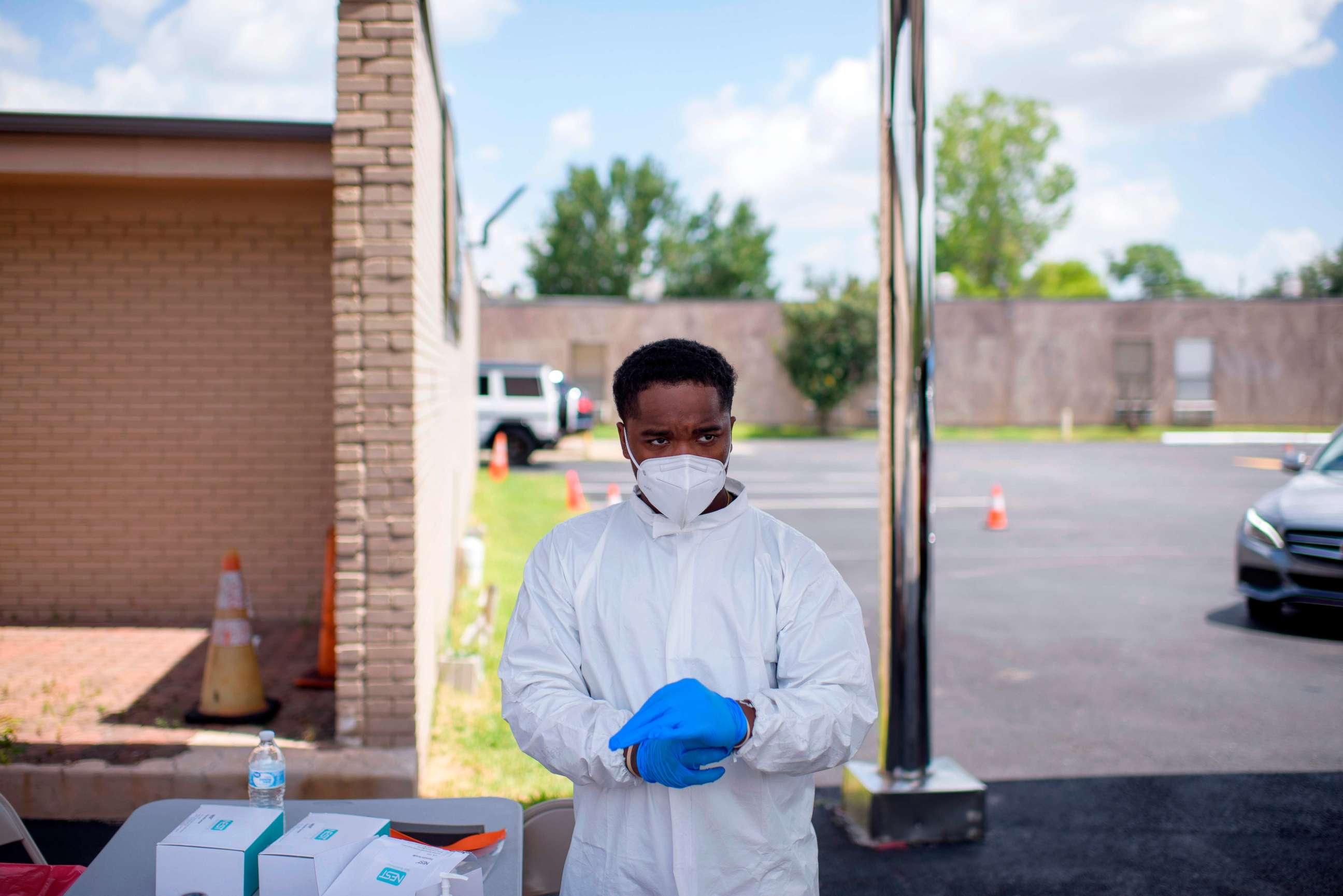 PHOTO: A health care worker puts on additional personal protective equipment at a COVID-19 testing site at United Memorial Medical Center in Houston, on July 9, 2020.