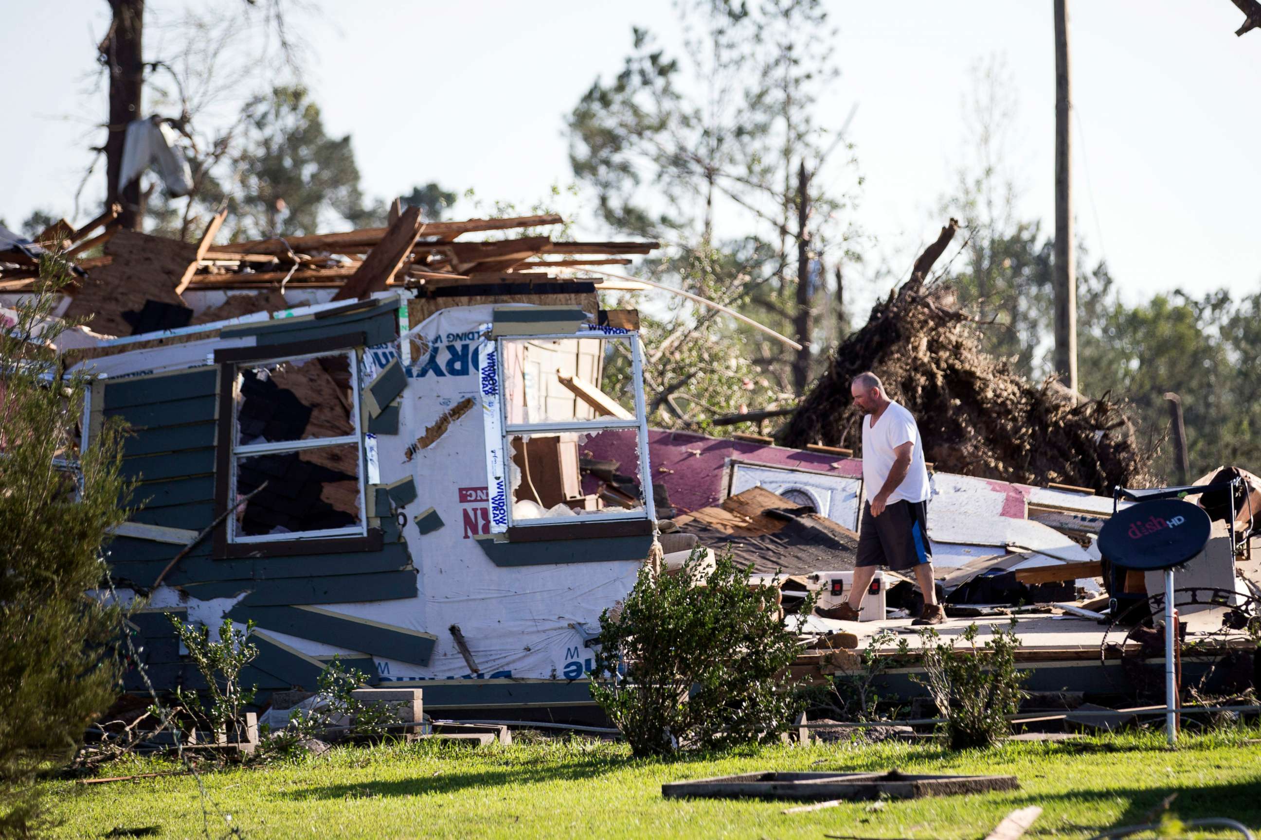 PHOTO: David Maynard sifts through the rubble searching for his wallet, Thursday, April 23, 2020 in Onalaska, Texas, after a tornado destroyed his home the night before.