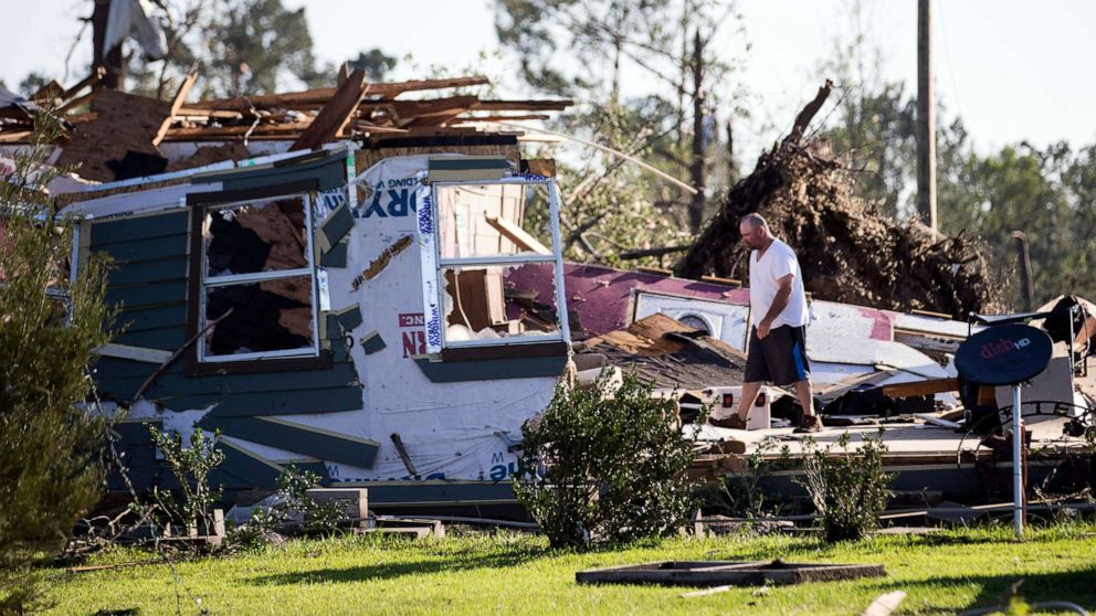 PHOTO: David Maynard sifts through the rubble searching for his wallet, Thursday, April 23, 2020 in Onalaska, Texas, after a tornado destroyed his home the night before.
