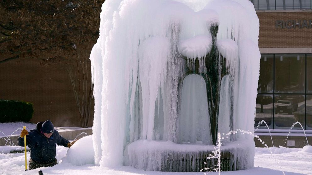 PHOTO: City of Richardson worker clears ice from a frozen water fountain, Feb. 16, 2021, in Richardson, Texas.