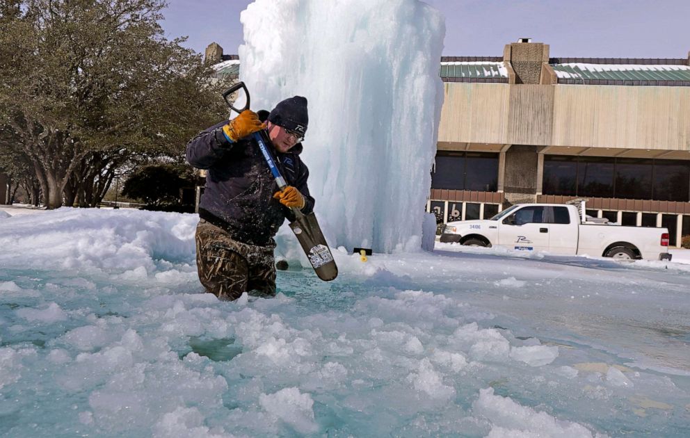 PHOTO: City of Richardson worker breaks ice on a frozen fountain, Feb. 16, 2021, in Richardson, Texas.