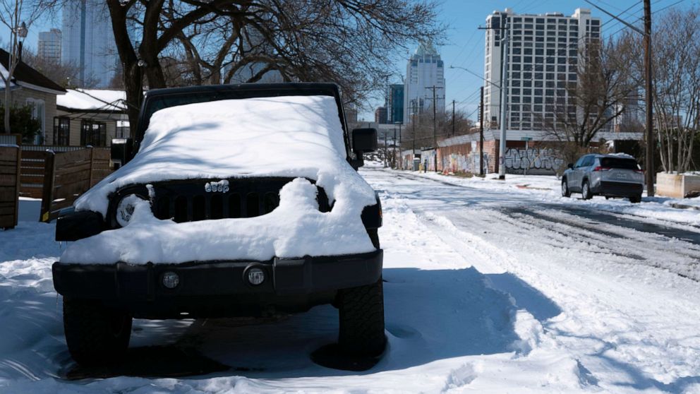 PHOTO: A parked Jeep is covered in snow Tuesday, Feb. 16, 2021, in Austin, Texas.