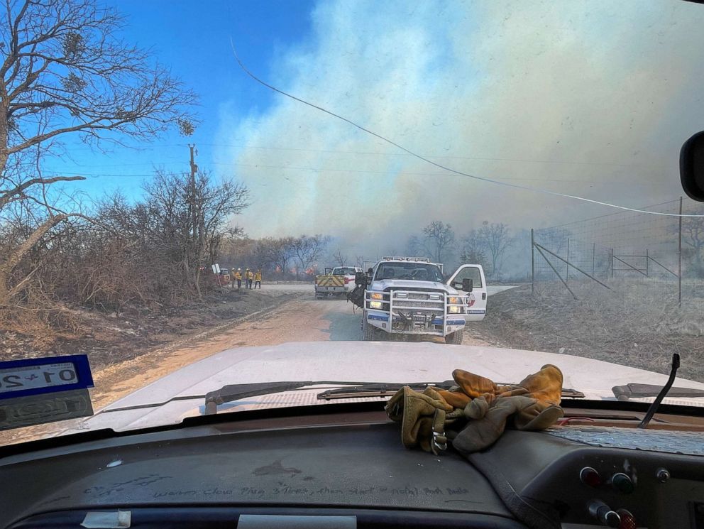 PHOTO: In this picture obtained from social media, firefighters work at a site as the Eastland Complex wildfire burns near Rising Star, Eastland County, Texas, on March 18, 2022.