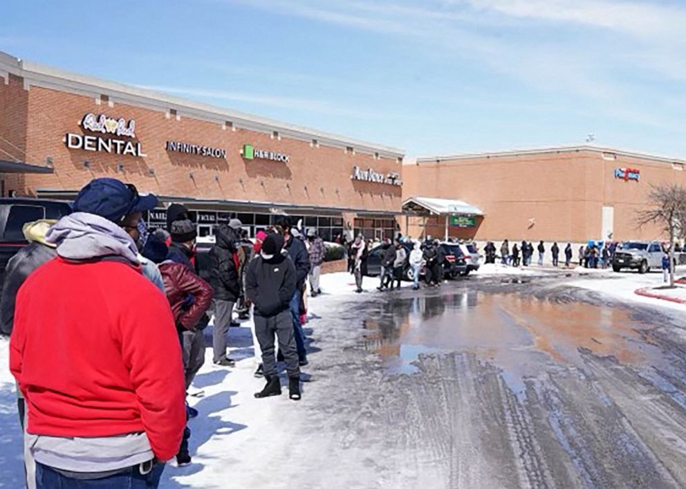 PHOTO: People wait in line at a mall to get inside a supermarket in Round Rock, Texas, on Feb. 16, 2021.