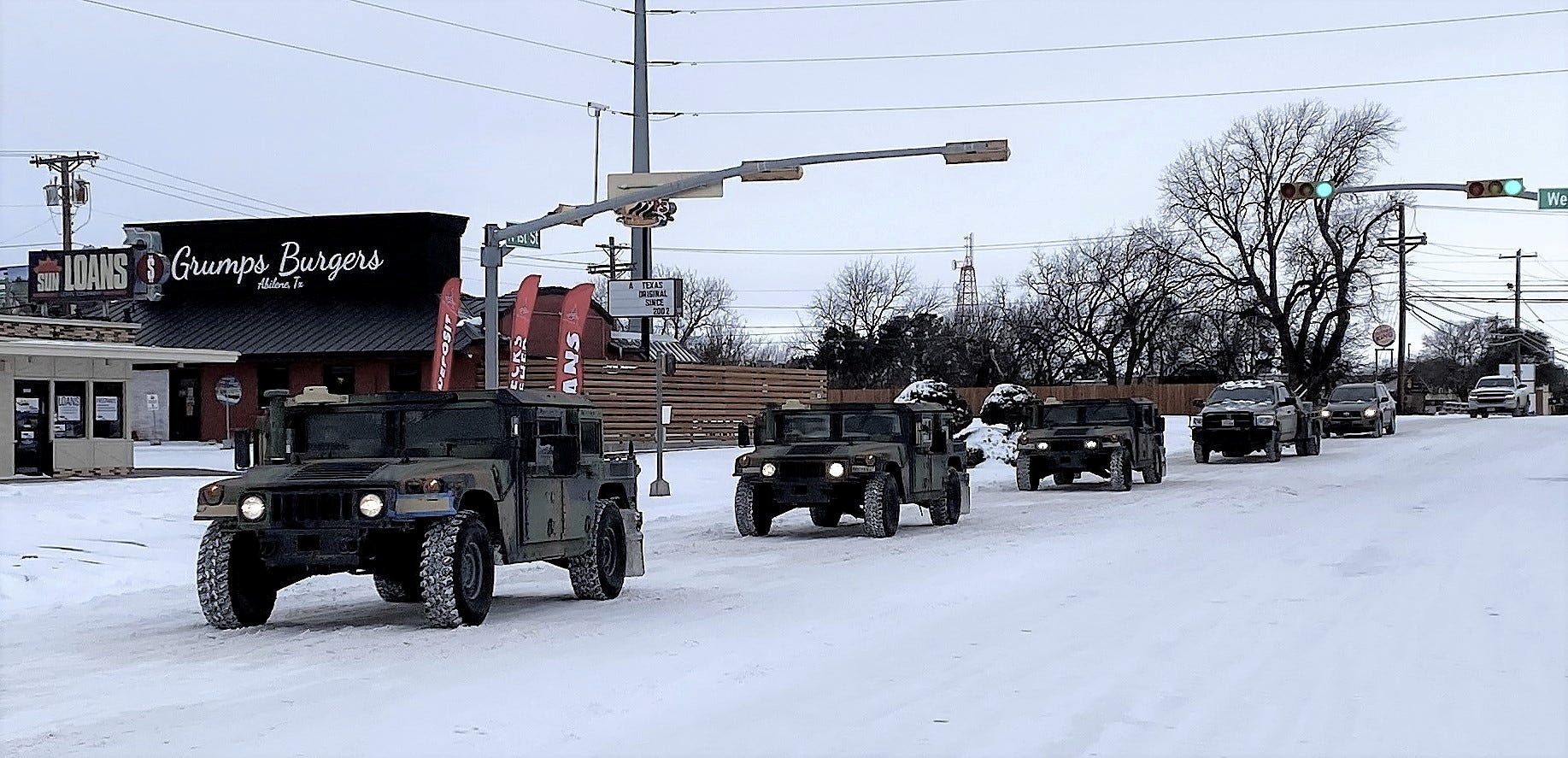 PHOTO: Military vehicles from the Texas Military Department of the Texas National Guard, tasked to transport residents to designated warming centers and other required duties, form a convoy in Abilene, Texas, Feb. 16, 2021.