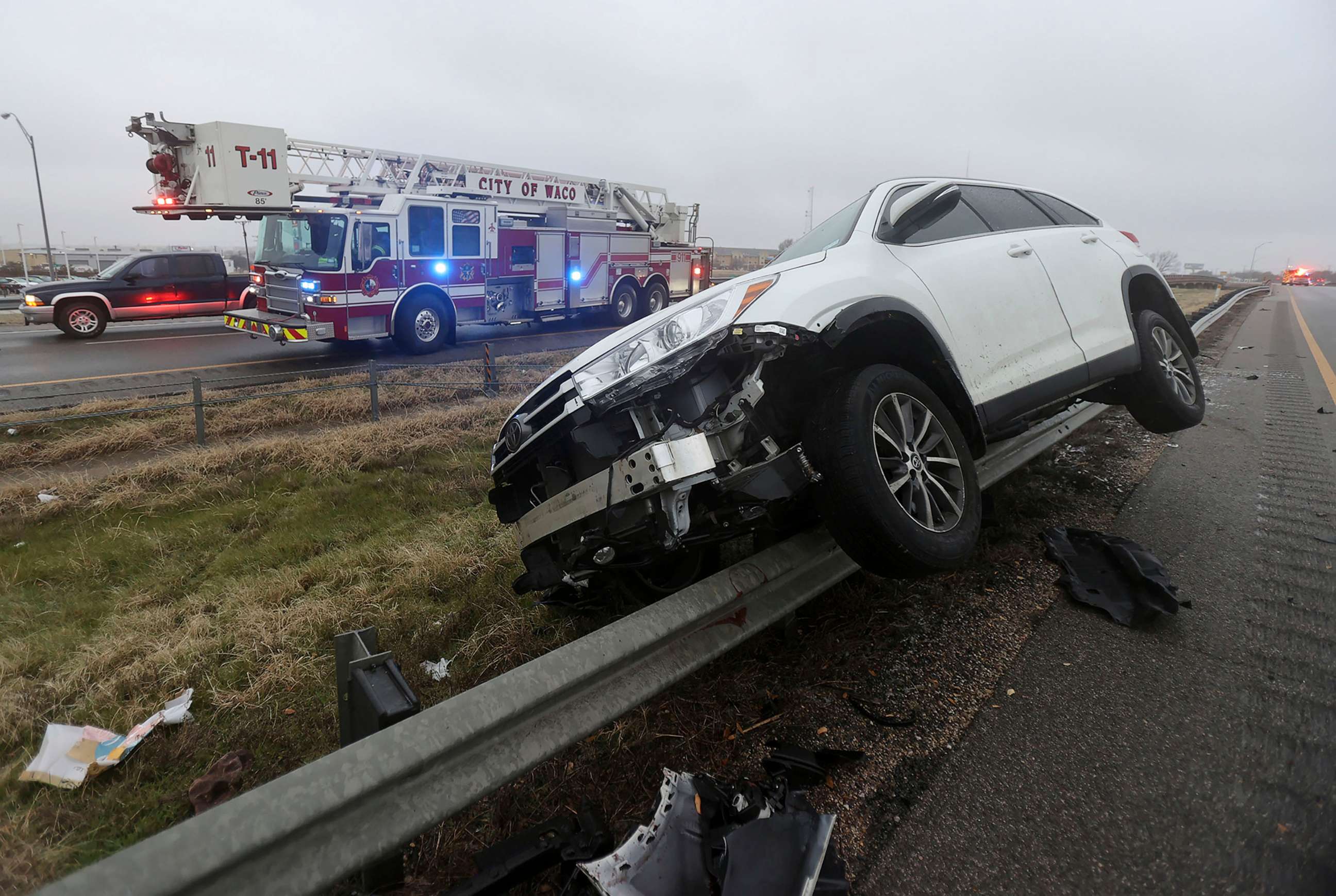 PHOTO: A vehicle rests on a barricade as the driver lost control and slid off Highway 6, Jan. 31, 2023 in Waco, Texas.