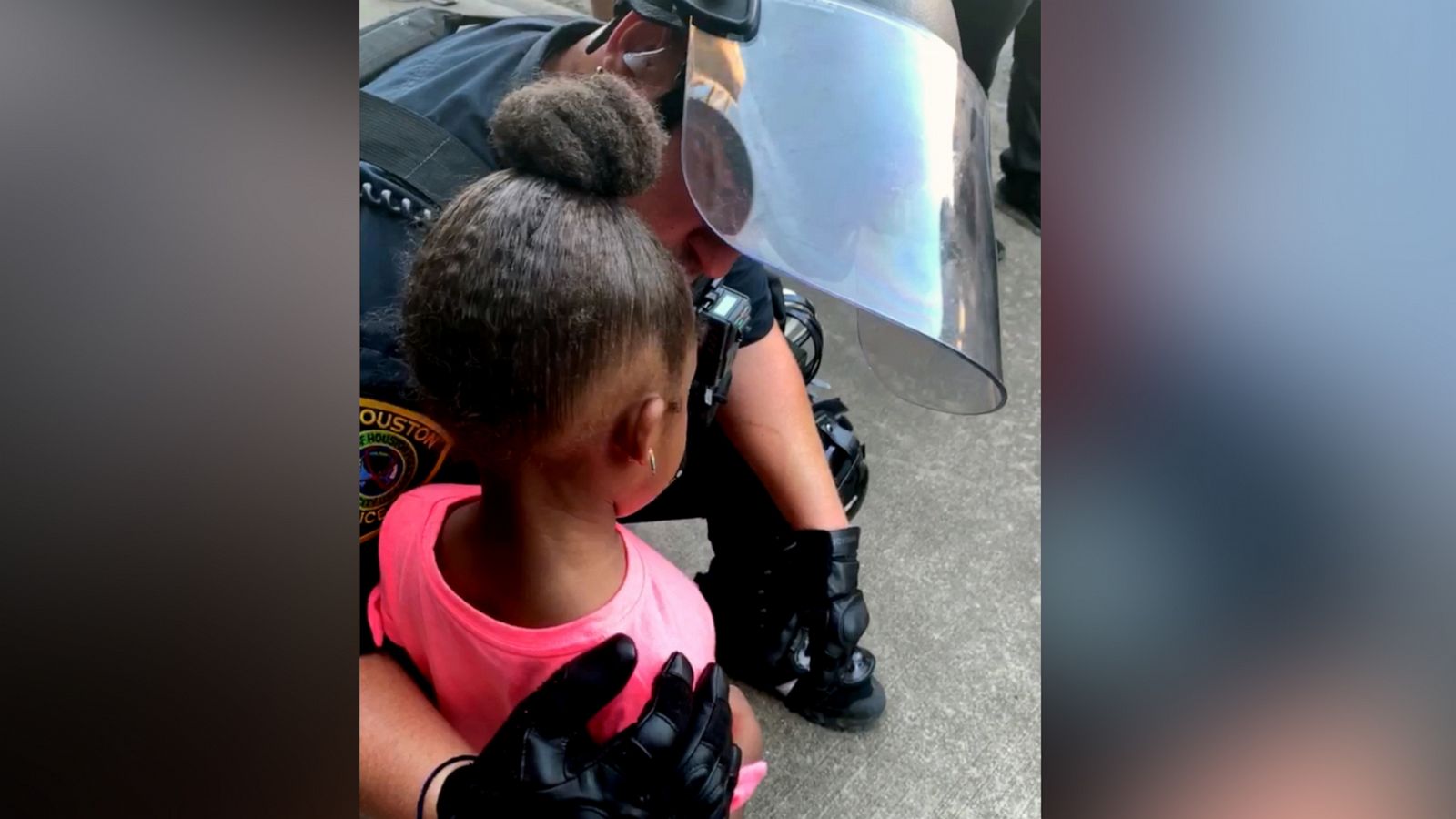 PHOTO: A police officer comforts a little girl during a protest in Houston, June 2, 2020.