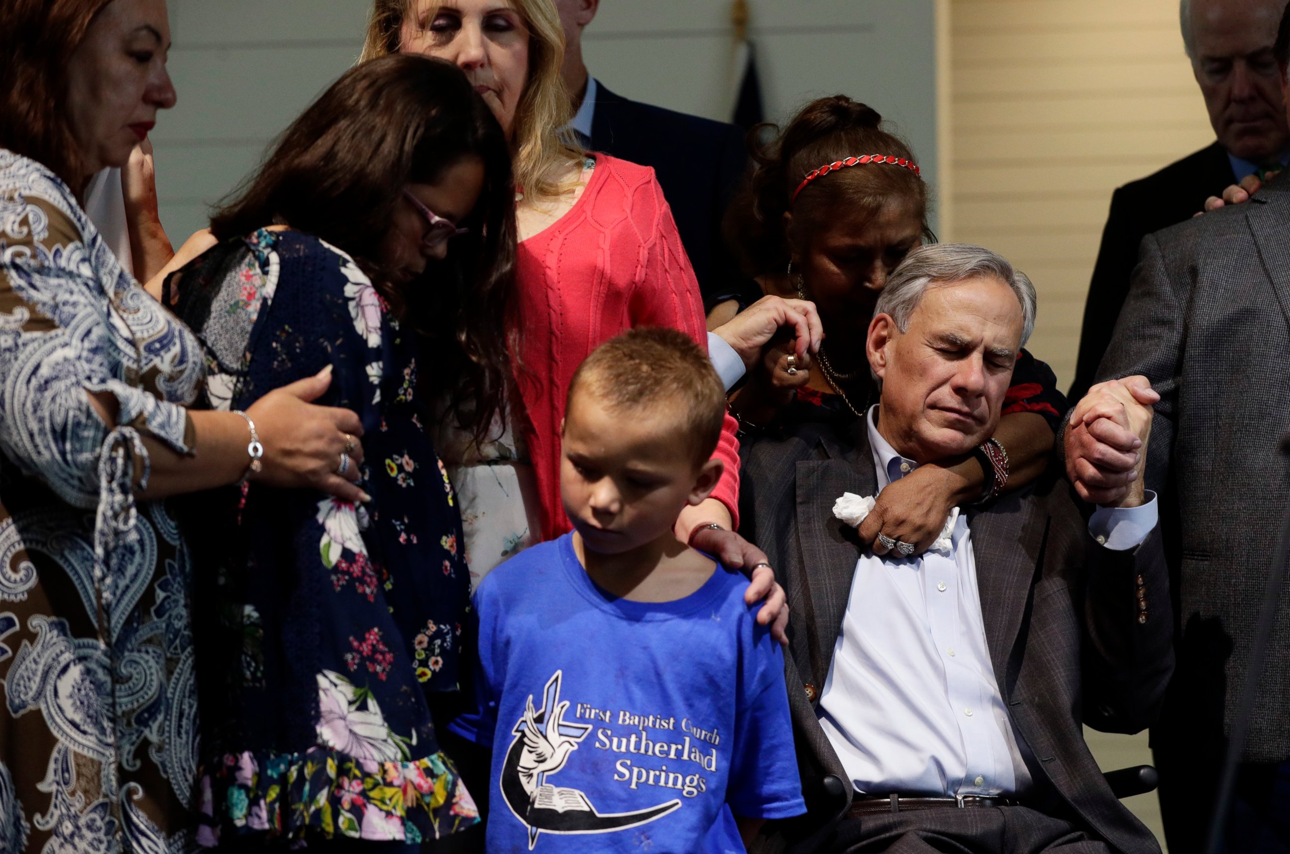 PHOTO: Texas Gov. Greg Abbott, right, holds hands with survivors during a dedication ceremony for a new sanctuary and memorial room at the First Baptist Church in Sutherland Springs, Texas, Sunday, May 19, 2019.