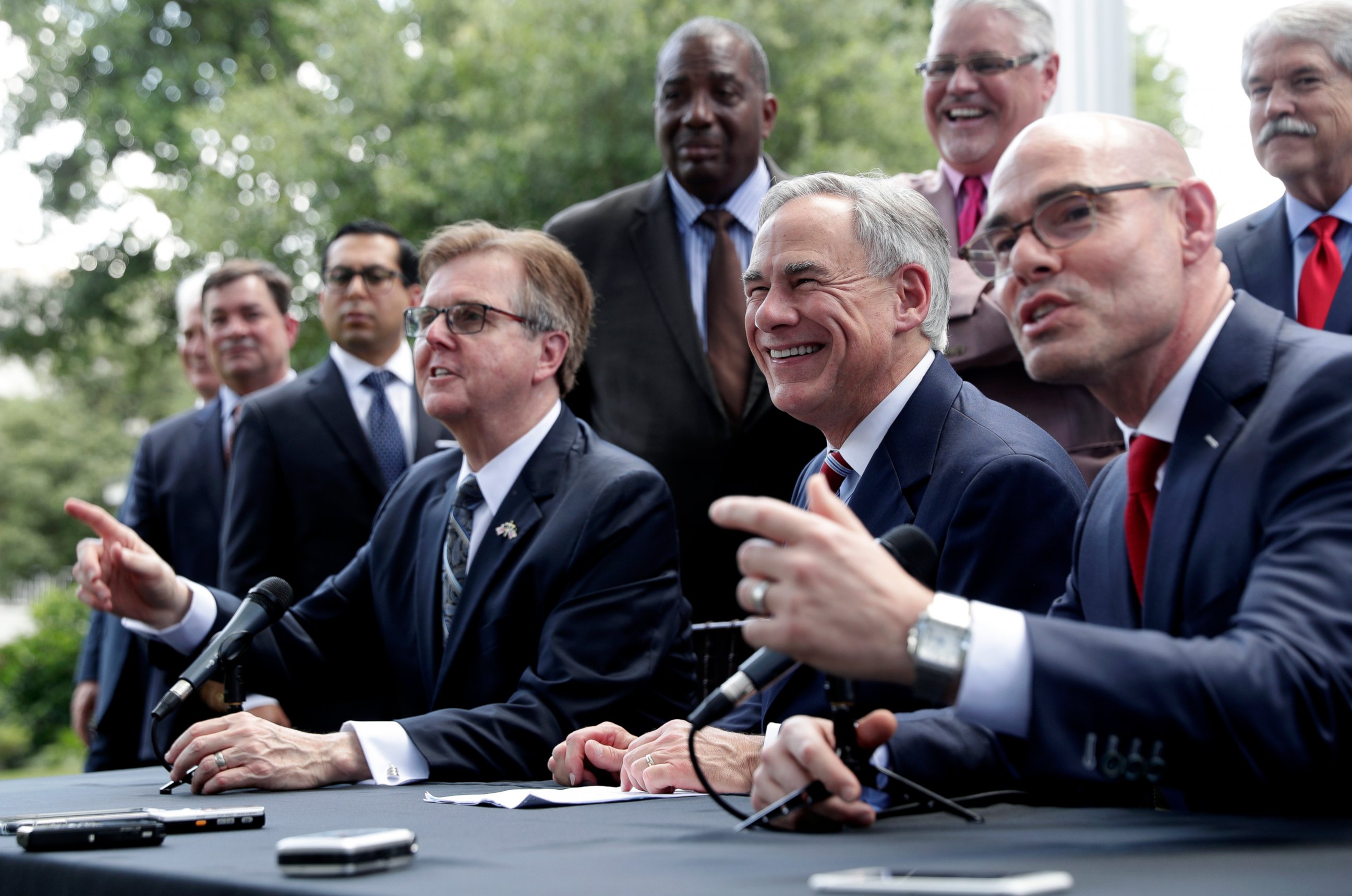 PHOTO: Texas Gov. Greg Abbott, Lt. Governor Dan Patrick, and Speaker of the House Dennis Bonnen, seated right, and other law makers attend a joint press conference to discuss teacher pay and school finance.