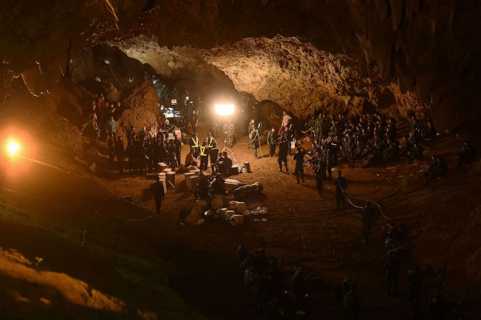 PHOTO: Thai soldiers relay electric cable deep into the Tham Luang cave at the Khun Nam Nang Non Forest Park in Chiang Rai on June 26, 2018.