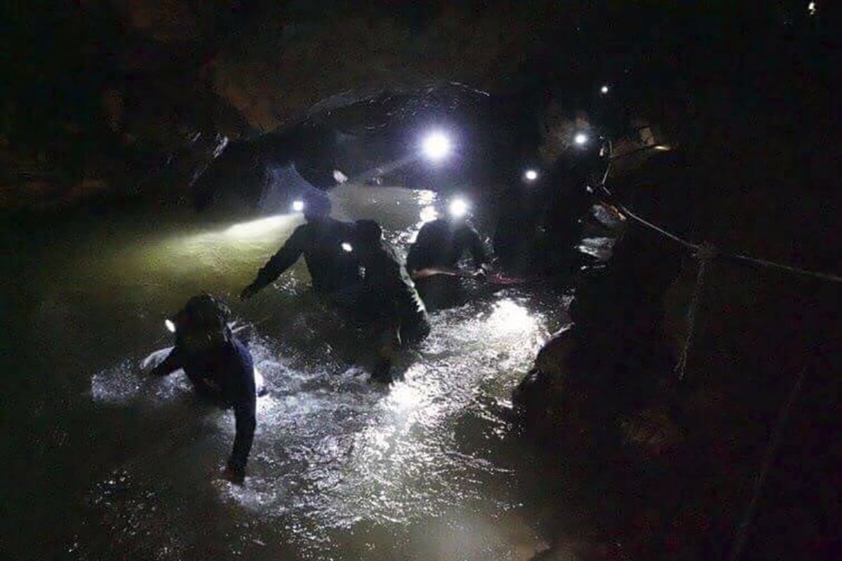 PHOTO: Thai rescue teams walk inside cave complex where 12 boys and their soccer coach went missing, in Mae Sai, Chiang Rai province, in northern Thailand, July 2, 2018.