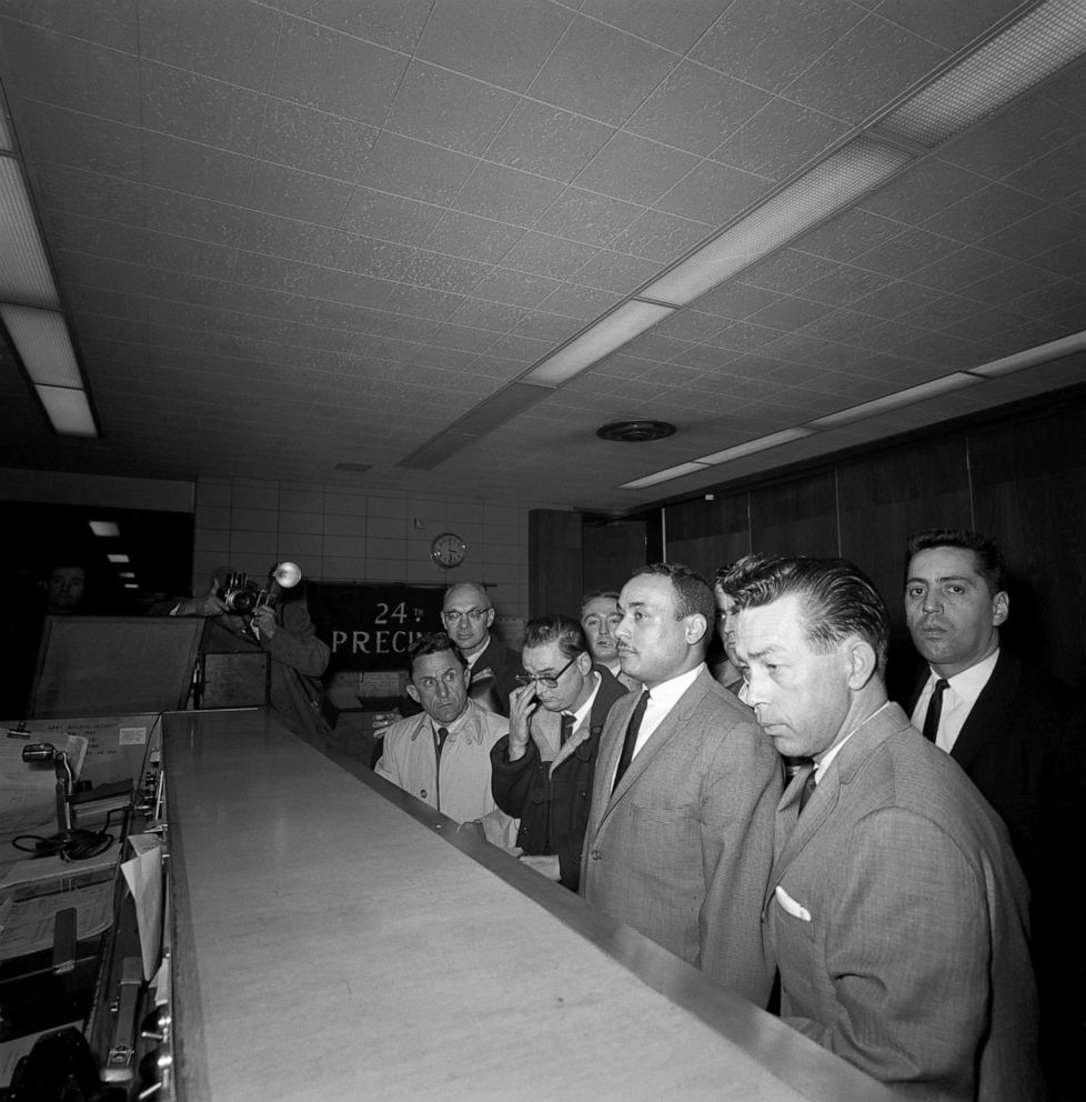 PHOTO: Thomas 15X Johnson, 30, center, arrives at the police station to be booked for the homicide of Malcolm X, March 3, 1965, in New York City.