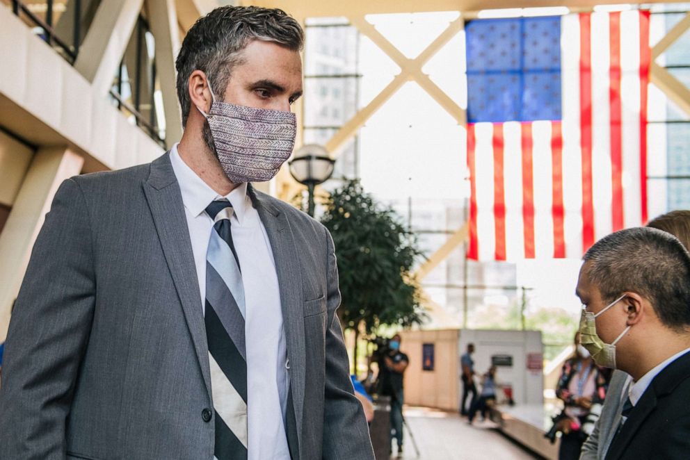 PHOTO: In this July 21, 2020, file photo, former Minneapolis Police officers Thomas Lane (L) and Tou Thao pass each other ahead of a courthouse appearance at the Hennepin County Government Center in Minneapolis.