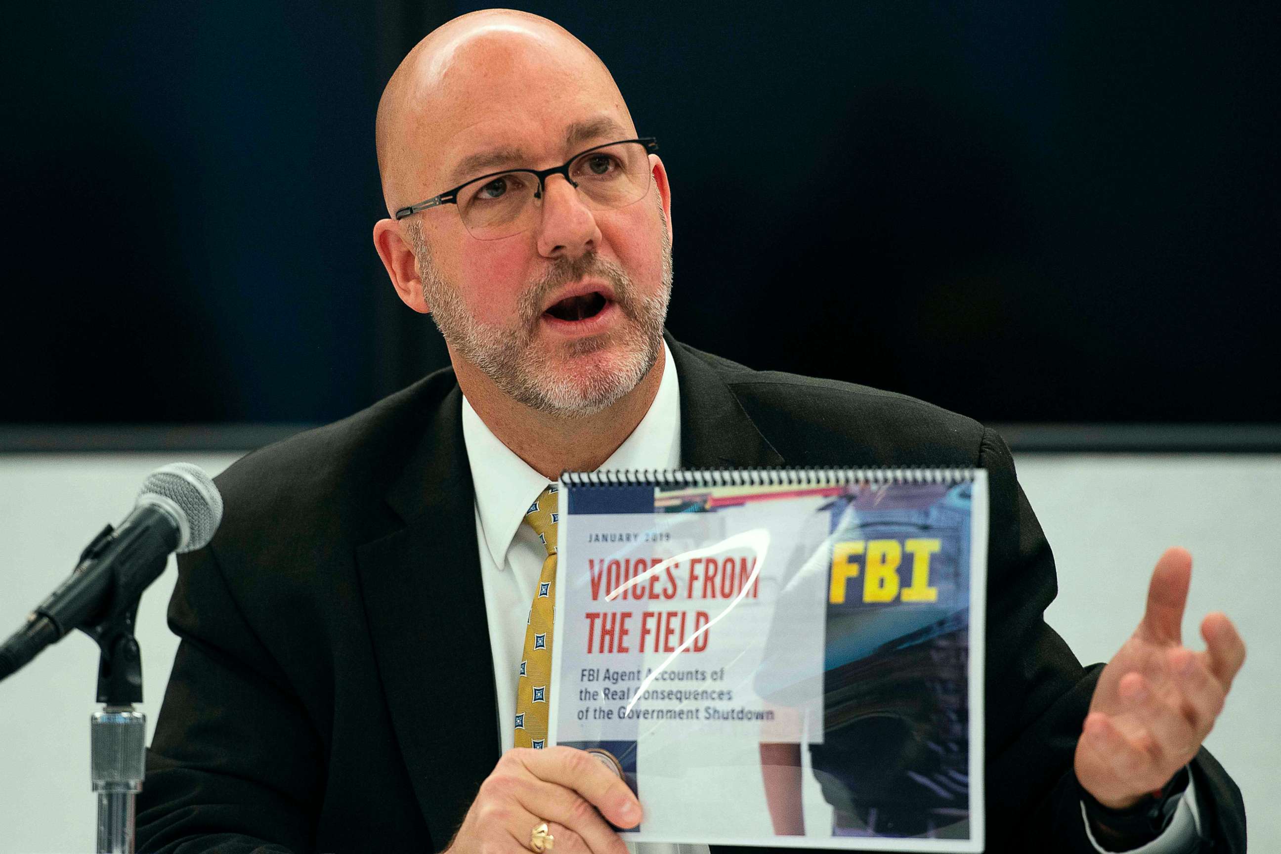 PHOTO: Thomas O'Connor holds up an FBI report "Voices From the Field" giving examples of how the government shutdown is undermining their work on drug and gang enforcement during a press conference in Washington, DC, Jan. 22, 2019.