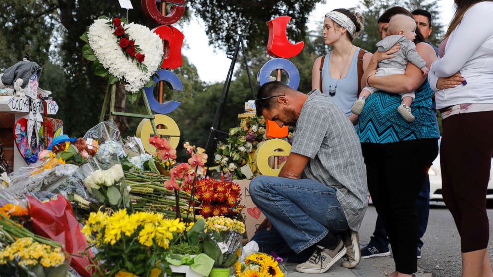 PHOTO: Jason Coffman, father of slain victim Cody Coffman, kneels at a memorial not far from where the Borderline Bar and Grill shooting happened in Thousand Oaks, Calif., Nov. 15, 2018.