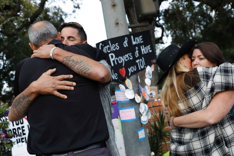 PHOTO: Jason Coffman, father of slain victim Cody Coffman, gets a hug at a vigil site for the shooting victims near the Borderline Bar and Grill, Nov. 7, 2018 in Thousand Oaks, Calif.