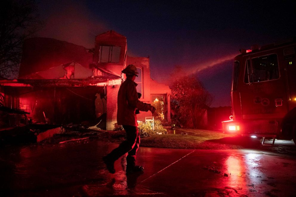 PHOTO: A firefighter assesses the damage of a home from the Tick Fire, Thursday, Oct. 24, 2019, in Santa Clarita, Calif.