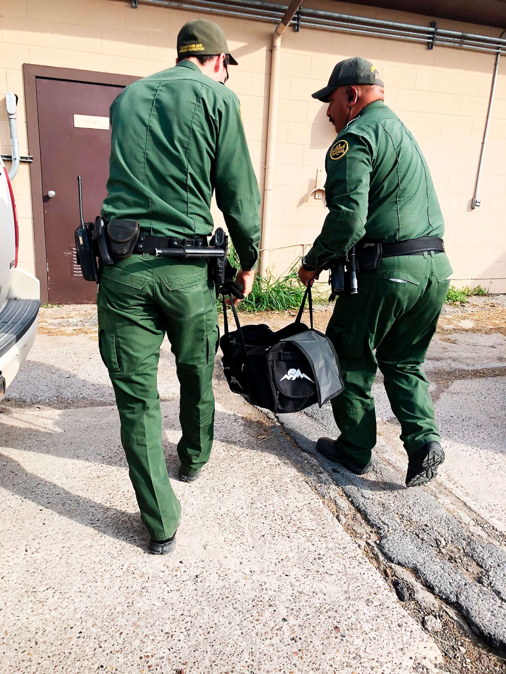 PHOTO: U.S Customs and Border Protection agents carrying a male tiger in a duffle bag that was seized at the border near Brownsville, Texas, into the the Gladys Porter Zoo in Brownsville, April 30, 2018.