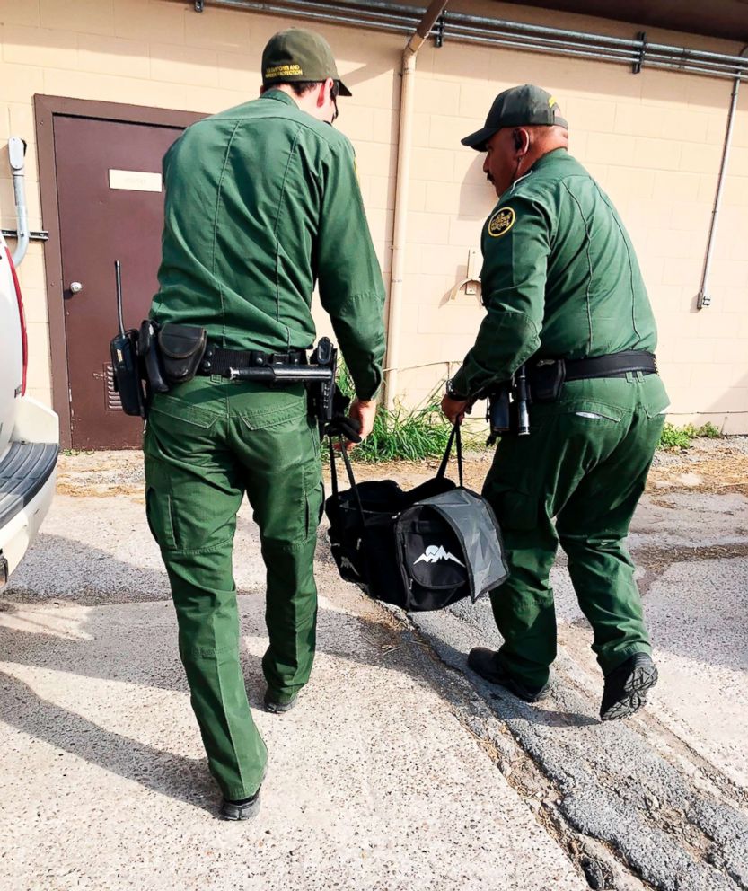 PHOTO: U.S Customs and Border Protection agents carrying a male tiger in a duffle bag that was seized at the border near Brownsville, Texas, into the the Gladys Porter Zoo in Brownsville, April 30, 2018.