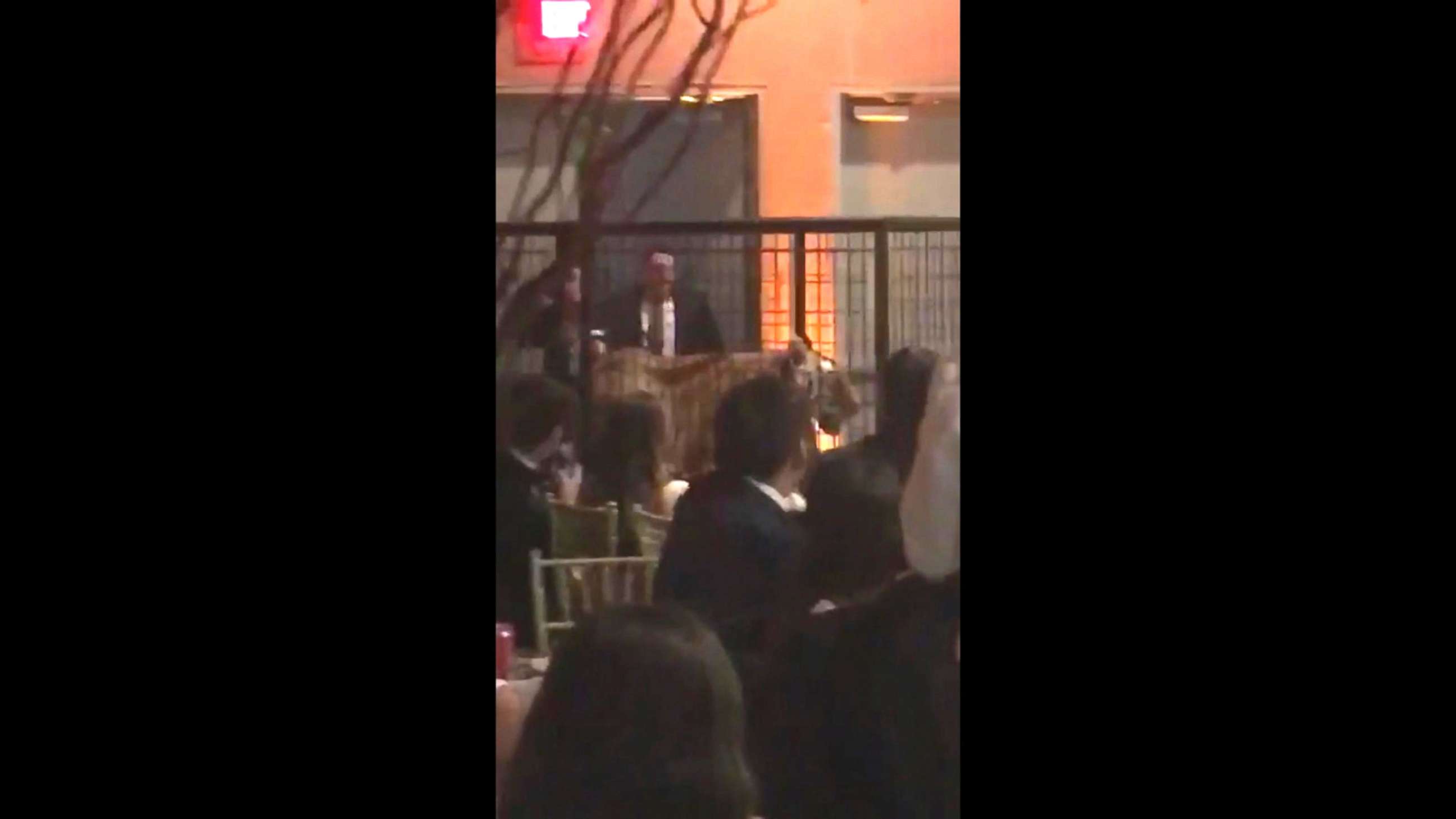 PHOTO: A handler is captured on cell phone video wheeling out a caged tiger on Friday as many Miami prom dance attendees from Christopher Columbus High School get out their cell phones to record the moment. 
