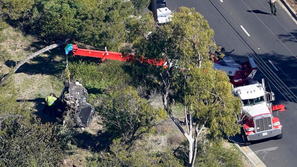 PHOTO: A crane is used to lift a vehicle following a rollover accident involving golfer Tiger Woods, Feb. 23, 2021, in Rancho Palos Verdes, Calif., a suburb of Los Angeles.