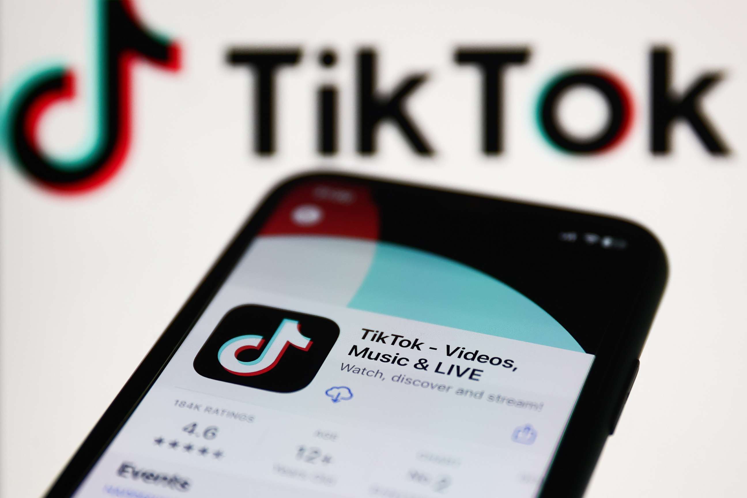 PHOTO: TikTok on App Store displayed on a phone screen and TikTok logo displayed on a screen in the background are seen in this illustration photo on Jan. 30, 2023.