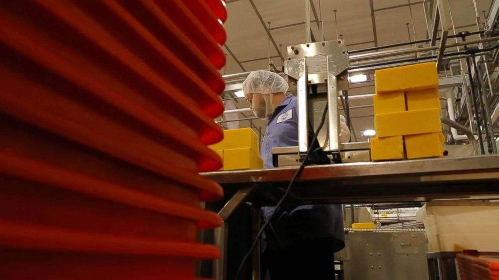 PHOTO: A worker processes blocks of cheese at Tillamook Creamery in Tillamook, Ore.