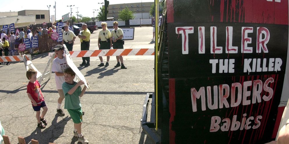 PHOTO: Children and anti-abortion protesters gather at a Wichita, Kan. abortion clinic operated by Dr. George Tiller, July 21, 2001.