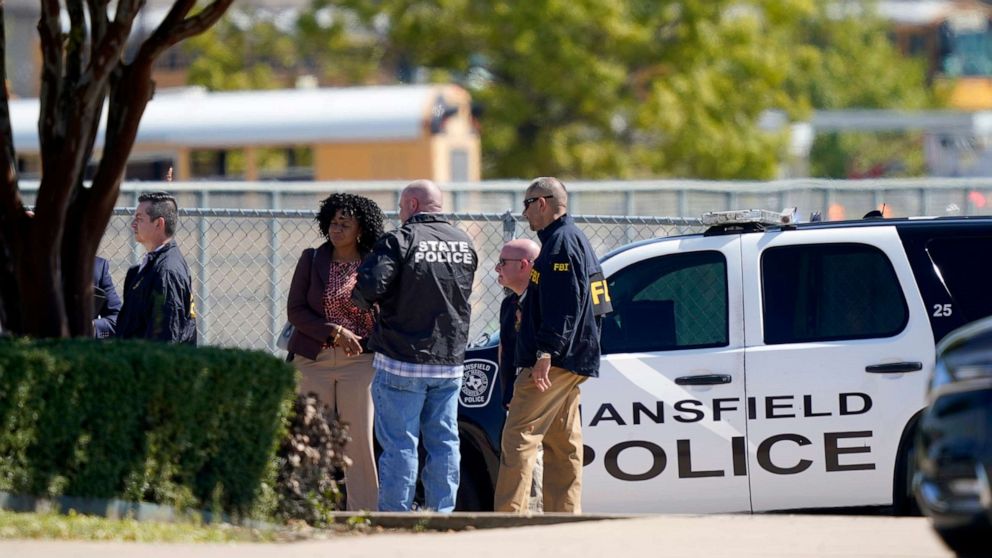 PHOTO: Law enforcement officers from different agencies gather in the parking lot of Timberview High School after a shooting inside the school located in south Arlington, Texas, Oct. 6, 2021. 