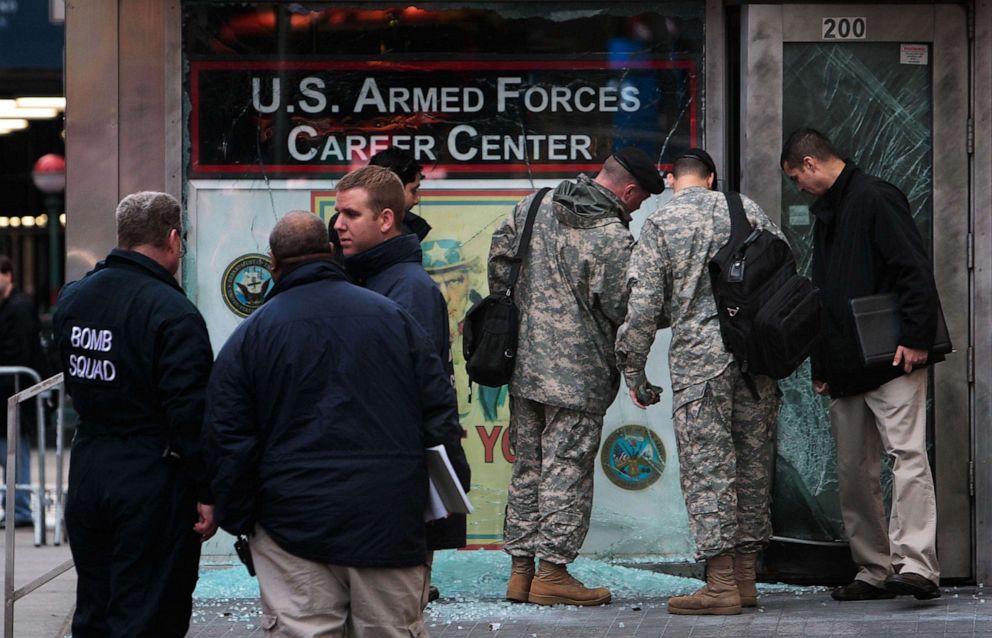 PHOTO: In this March 6, 2008, file photo, city officials and members of the US military stand in front of a US military recruiting station in Times Square after an early-morning explosion in New York.