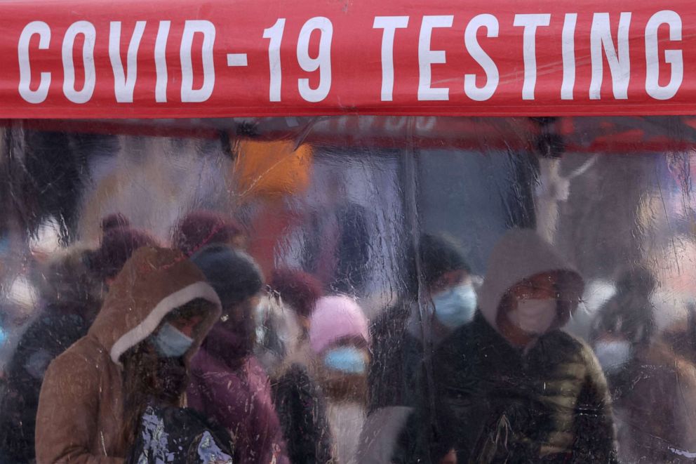 PHOTO: People queue to be tested for COVID-19 in Times Square, as the Omicron coronavirus variant continues to spread in New York City, Dec. 20, 2021.