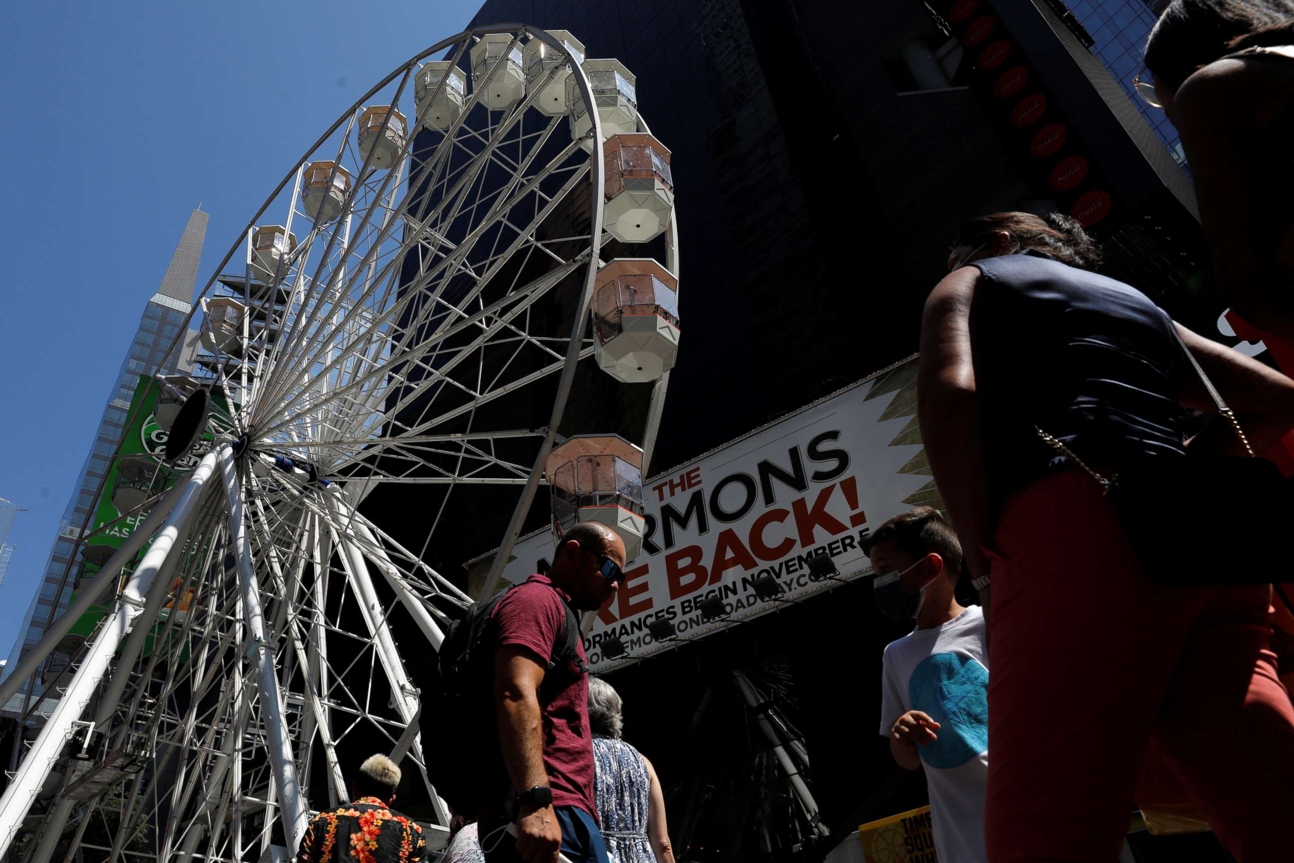 PHOTO: People queue to ride the Times Square Wheel, a Ferris wheel constructed in Times Square, in New York, Aug. 25, 2021.