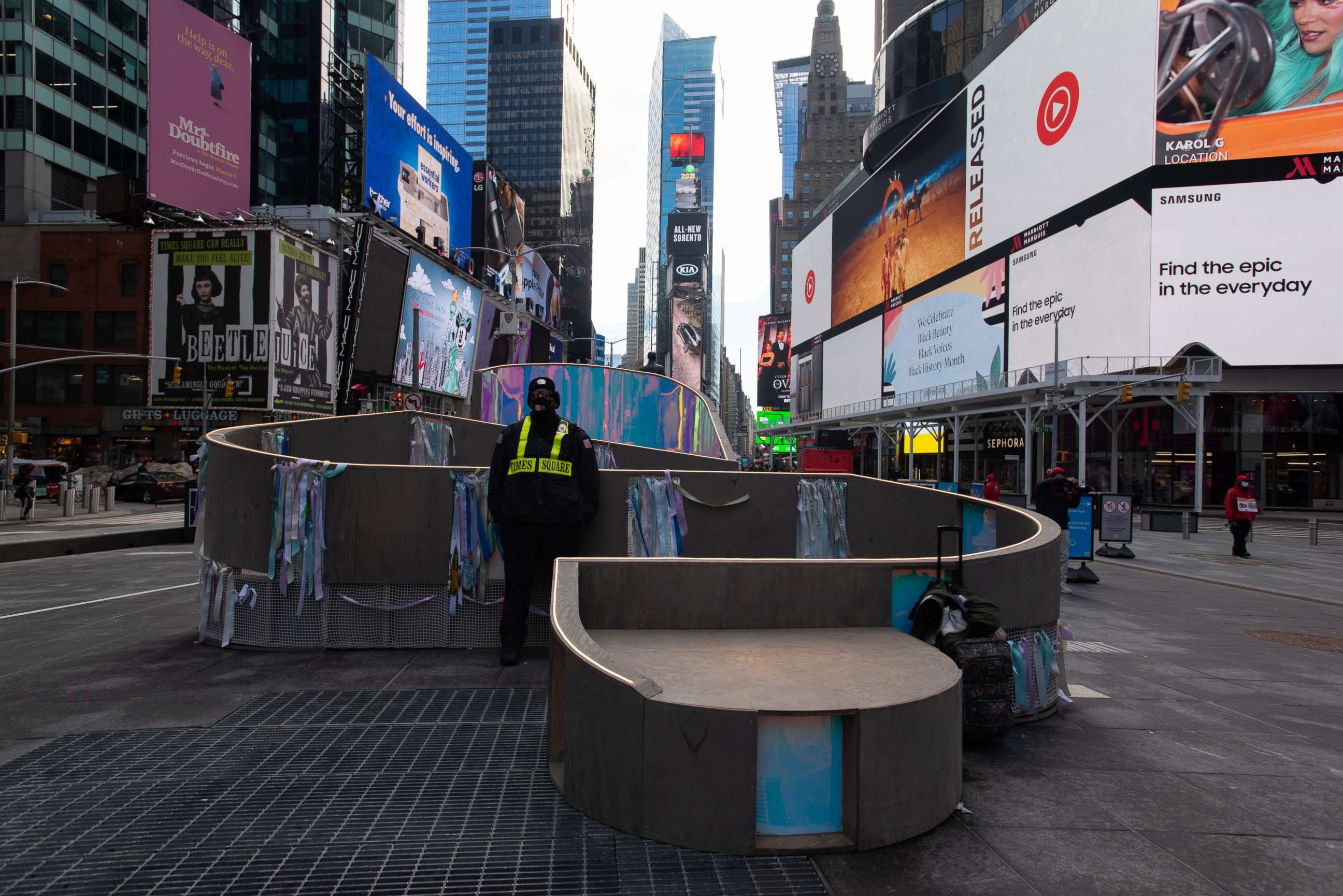 PHOTO: A security guard stands with an art installation in New York's Times Square, Feb. 16, 2021.