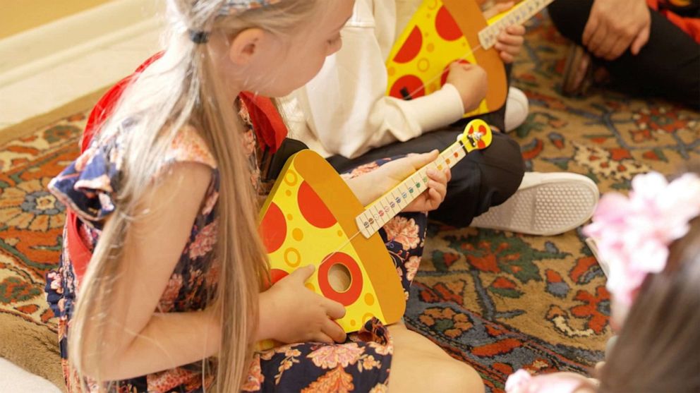 PHOTO: A girl plays a TinkerTar that's in the shape of a pizza slice. ABC News