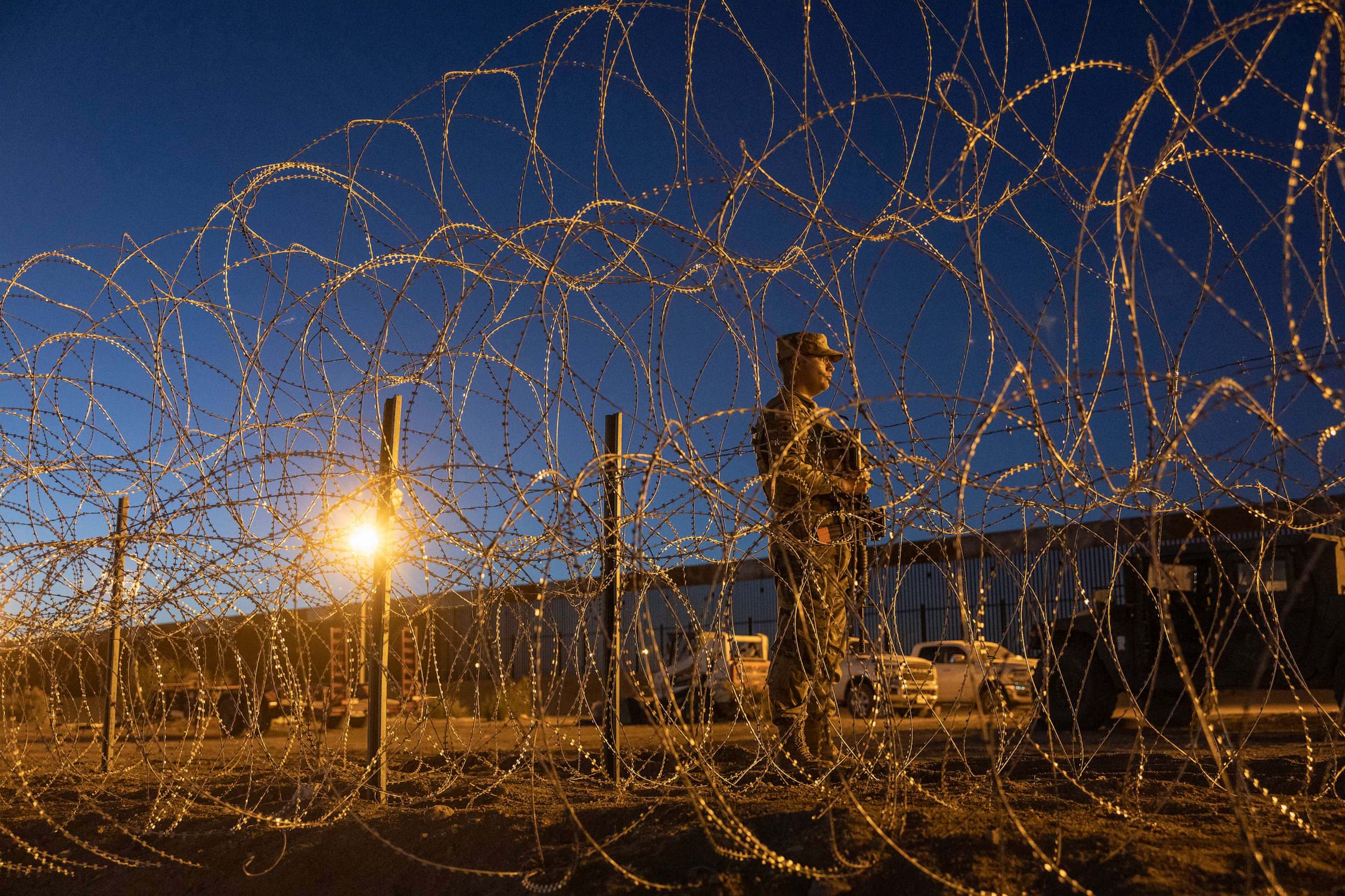 PHOTO: EL PASO, TEXAS - MAY 11: A Texas National Guard soldier stands vigil at a makeshift migrant camp near the U.S.-Mexico border fence on May 11, 2023 in El Paso, Texas.