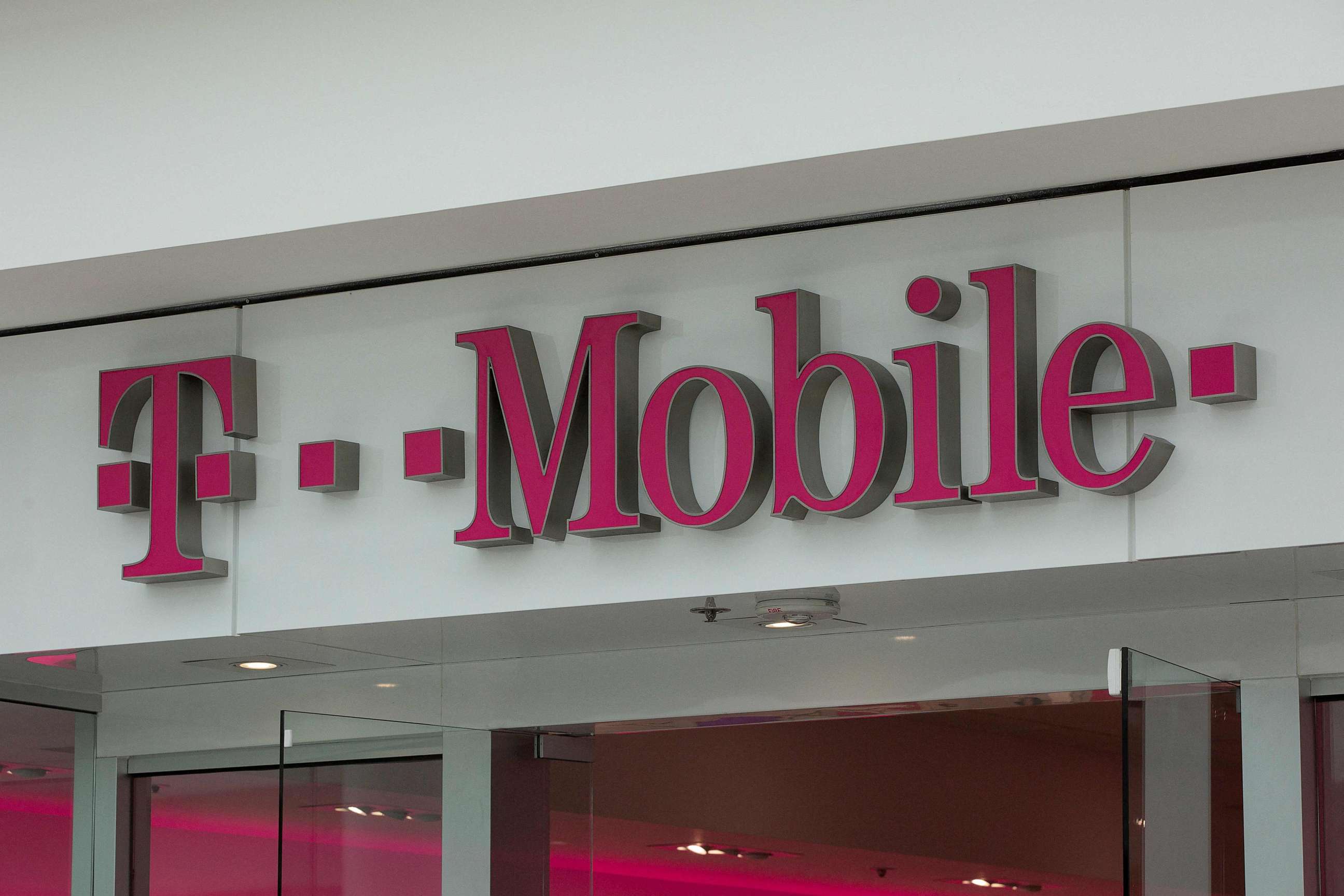 PHOTO: (FILES) In this file photo taken on July 26, 2019 The T-Mobile logo is seen outside a shop in Washington, DC. - US telecom company T-Mobile announced January 19, 2023 that a recent hack impacted 37 million of its customers' data.