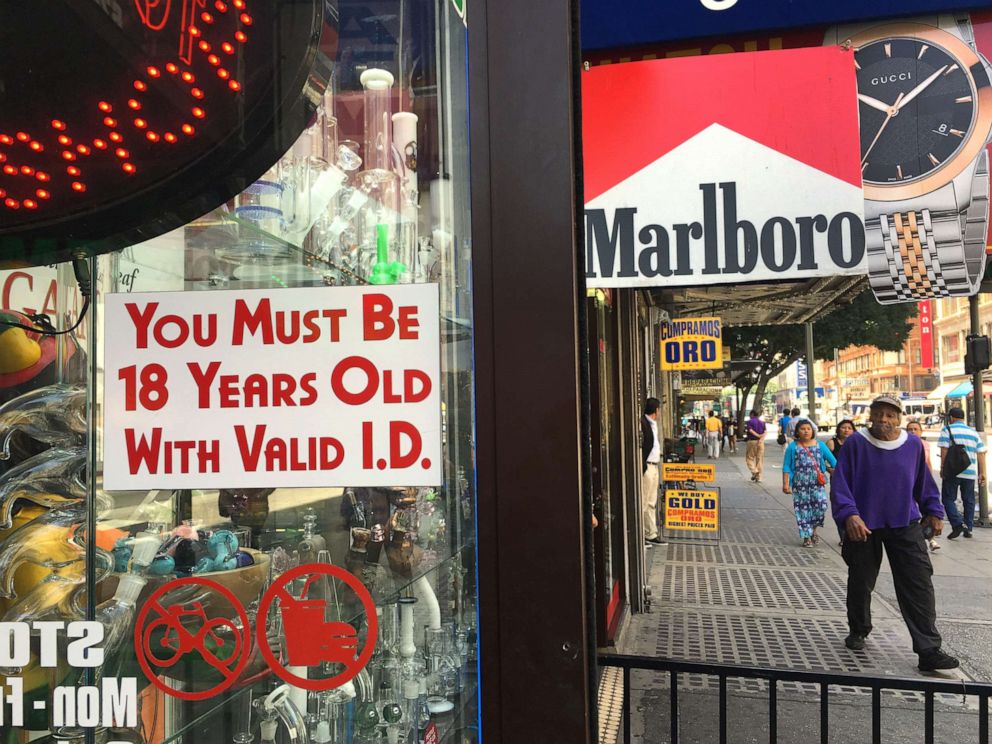 PHOTO: A sign posted outdoors at a smoke shop reads "You Must Be 18 Years Old with Valid I.D.," in downtown Los Angeles on Wednesday, June 8, 2016.